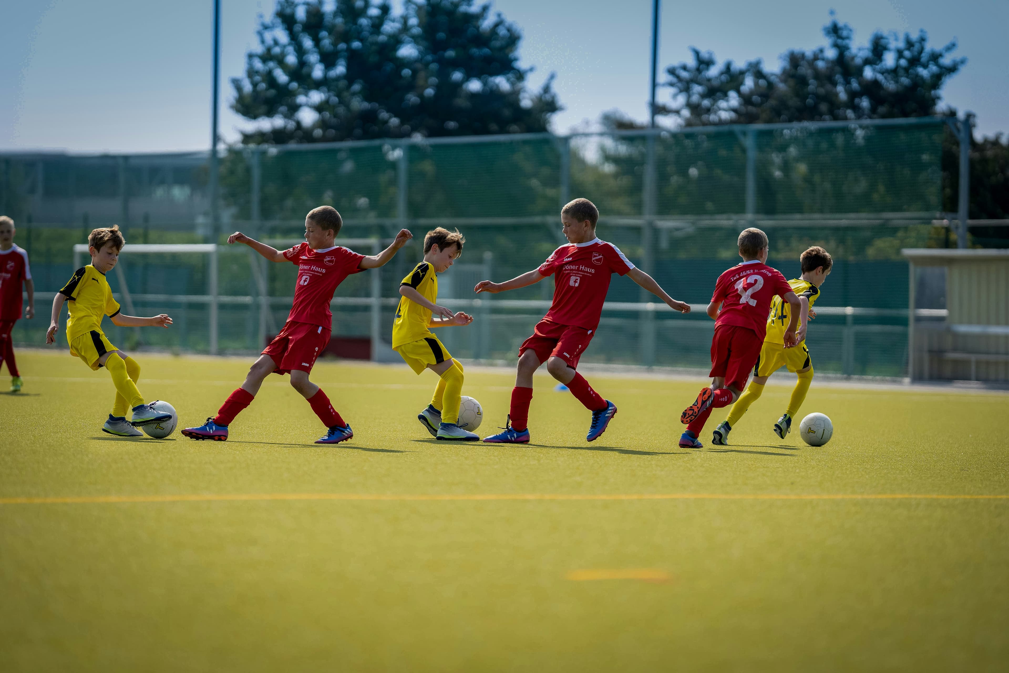 Kids playing football in a park